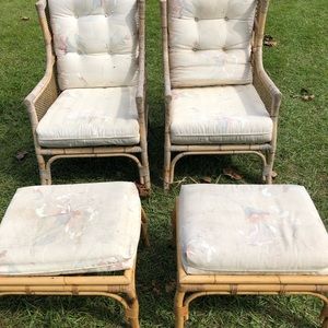Two Wicker chairs with matching foot rests.